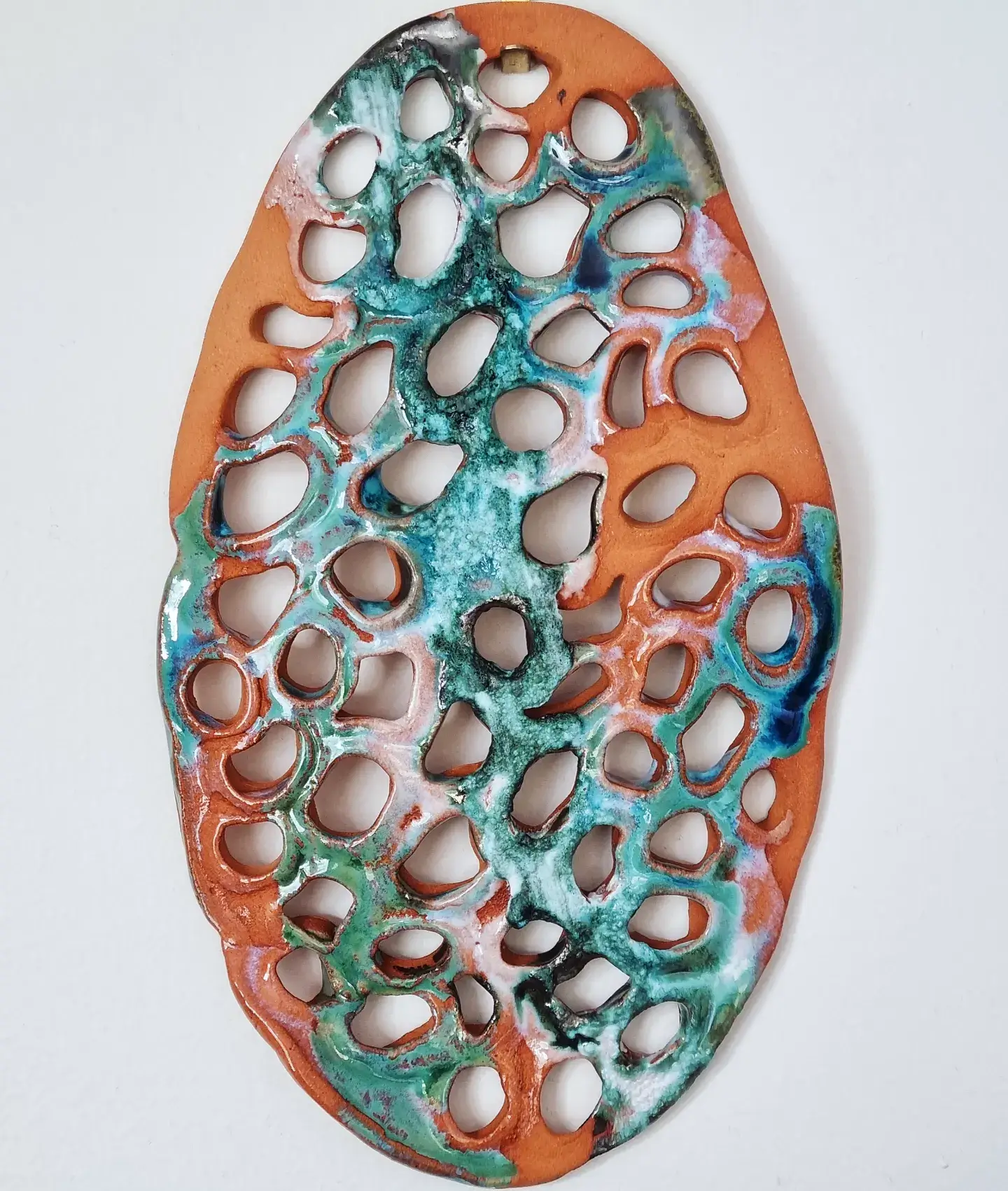 Trypophobia wall art ceramic sculpture in terracotta and blue green colours
